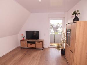 a living room with a television on a dresser at Komfort-Ferienwohnung gierskopp.pur in Olsberg