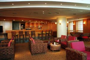 a lobby with chairs and a bar with a counter at Holiday Inn Citystars by IHG in Cairo +66 photos