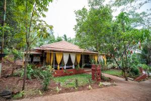 a small house in the middle of trees at Giri Mandala The Mountain Vihar in Welhe
