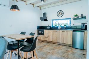 a kitchen with a wooden table and chairs and a table at Baltic Breeze & Spa in Władysławowo
