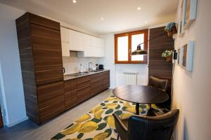 a kitchen with a table and chairs in a room at Appartamento La Perla in Brezzo +2 photos
