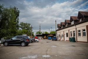 a group of cars parked in a parking lot at FELIX hostel in Dumbrăveni +11 photos