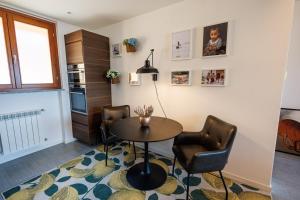 a dining room with a table and two chairs at Appartamento La Perla in Brezzo