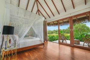 a bedroom with a bed with a view of a garden at Huma Terra Lodges in Hikkaduwa +144 photos