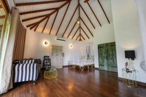 a living room with a couch and a table at Huma Terra Lodges in Hikkaduwa