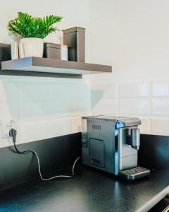 a coffee maker sitting on a counter in a kitchen at Baltic Breeze & Spa in Władysławowo +22 photos