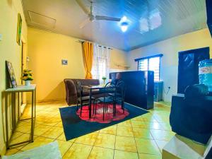 a living room with a table and chairs at Diani Escape in Ukunda
