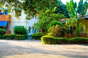a courtyard of a building with trees and plants at Diani Escape in Ukunda