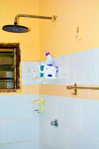 a bathroom with a sink and a mirror at Diani Escape in Ukunda +6 photos