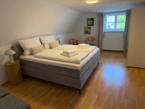 a bedroom with a large bed with two towels on it at Marktplatzapartment 2 in Höxter +5 photos
