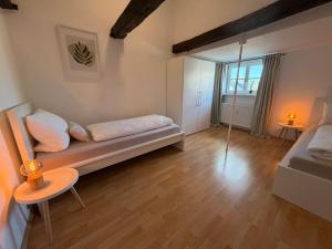 a room with a couch and a bed and a window at Marktplatzapartment 2 in Höxter