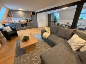 a living room with a couch and a table at Marktplatzapartment 2 in Höxter