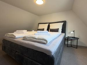 a large bed with two pillows on top of it at Marktplatzapartment 2 in Höxter