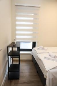 a bedroom with two beds and a window with a blind at SKYHILL 1 O1 Jahorna in Jahorina