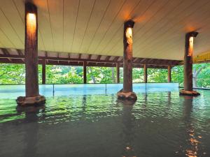 a pool of water in a building with pillars in it at Jozankei View Hotel in Jozankei