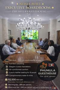 a group of people sitting around a table in a room at Phumula Farm Guesthouse in Nhlangano