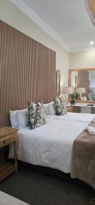 a bedroom with a large bed with pillows on it at Phumula Farm Guesthouse in Nhlangano