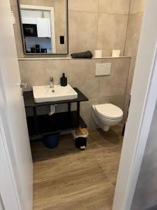 a bathroom with a sink and a toilet at Am Zollverein House-In Apartments Essen - Free Parking - WiFi - Kitchen in Essen +26 photos