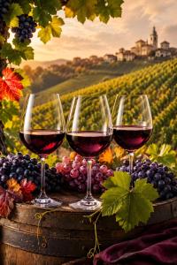four glasses of wine on a barrel with grapes at La Cascinassa in Tagliolo Monferrato +6 photos