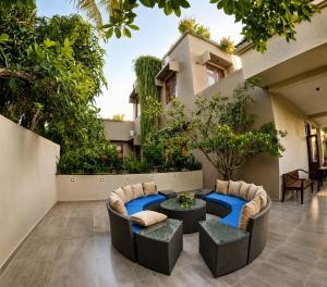 a patio with two couches and a table at Dhanora Dynasty Resort in Anuradhapura