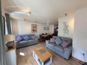 a living room with two couches and a table at The Galleries No 2 in Spean Bridge