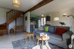 a living room with a blue couch and a table at Le Clos in Anthien +17 photos