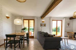 a living room with a couch and a table at Le Clos in Anthien