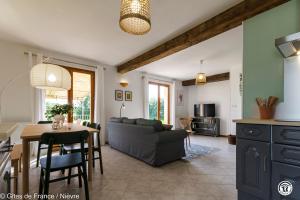a living room with a couch and a table at Le Clos in Anthien