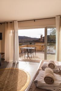 a bedroom with a view of a table and chairs at Clos Saint-Michel Resort & Spa in Malaucène +114 photos