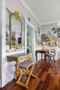a room with a mirror and a bench and a table at The Serangoon House Little India, Singapore, a Tribute Portfolio Hotel in Singapore +63 photos