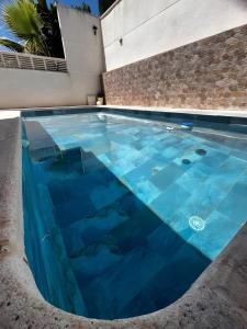 a swimming pool with blue water in a building at Sam in San Fulgencio
