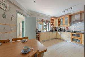 a kitchen with a wooden table and a dining room at Villa Praia Verde - Beach & Nature in Praia Verde