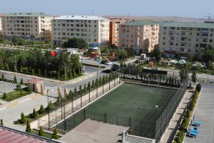 a tennis court in the middle of a city at New City Hotel in Masazır