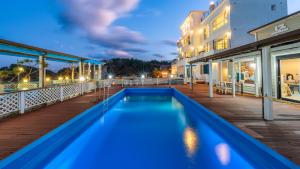 a pool on the deck of a hotel at night at Yangyang Monti Pet Spa Pension in Yangyang