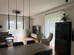a kitchen and living room with a black refrigerator at Kvissentali House in Tartu