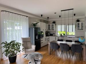a kitchen with a table and chairs and a dining room at Kvissentali House in Tartu