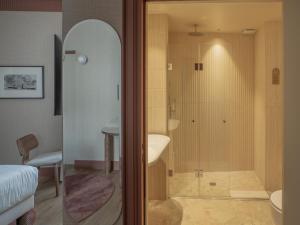 a bathroom with a shower with a toilet and a sink at Maison Atalaye - Hôtel entièrement rénové in Biarritz +75 photos