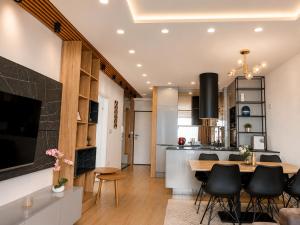 a kitchen and living room with a table and chairs at Euforia Ma Apartment Sarajevo in Sarajevo