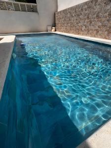 a swimming pool with blue water in a house at Sam in San Fulgencio +17 photos