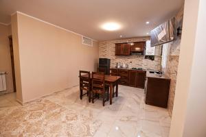 a kitchen with a table and chairs in a room at Hostel Bouchair Centre Ville Jijel in Jijel