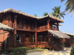 a wooden building with a straw roof at Nilaveli Beach Resort - Level 1 Certified in Nilaveli