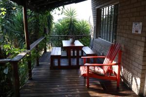 a wooden deck with a table and chairs on it at Numbi Hills Self-Catering in Hazyview
