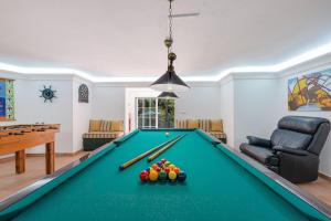 a pool table in a living room at Villa Praia Verde - Beach & Nature in Praia Verde