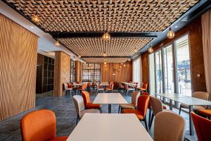 a restaurant with tables and chairs and windows at Zephyr Saidia in Saïdia