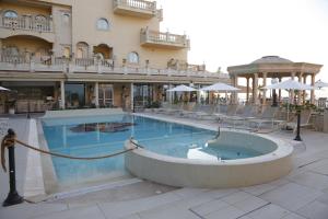 a large swimming pool in front of a hotel at Hellenia Yachting Hotel & SPA in Giardini Naxos