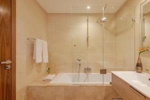 a bathroom with a shower and a tub and a sink at anfa Louise in Casablanca +22 photos