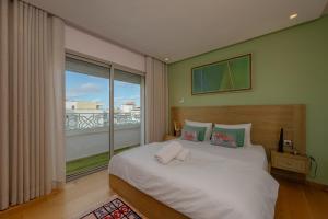 a bedroom with a large bed and a large window at anfa Louise in Casablanca