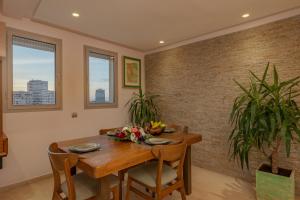 a dining room with a wooden table and some plants at anfa Louise in Casablanca
