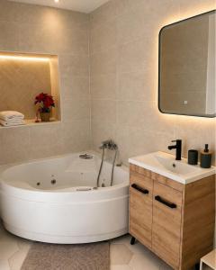 a bathroom with a large tub and a sink at A La Voile Blanche in Bouzigues +65 photos