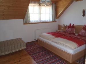 a bedroom with a large bed with red pillows at Russbachbauer in St. Wolfgang